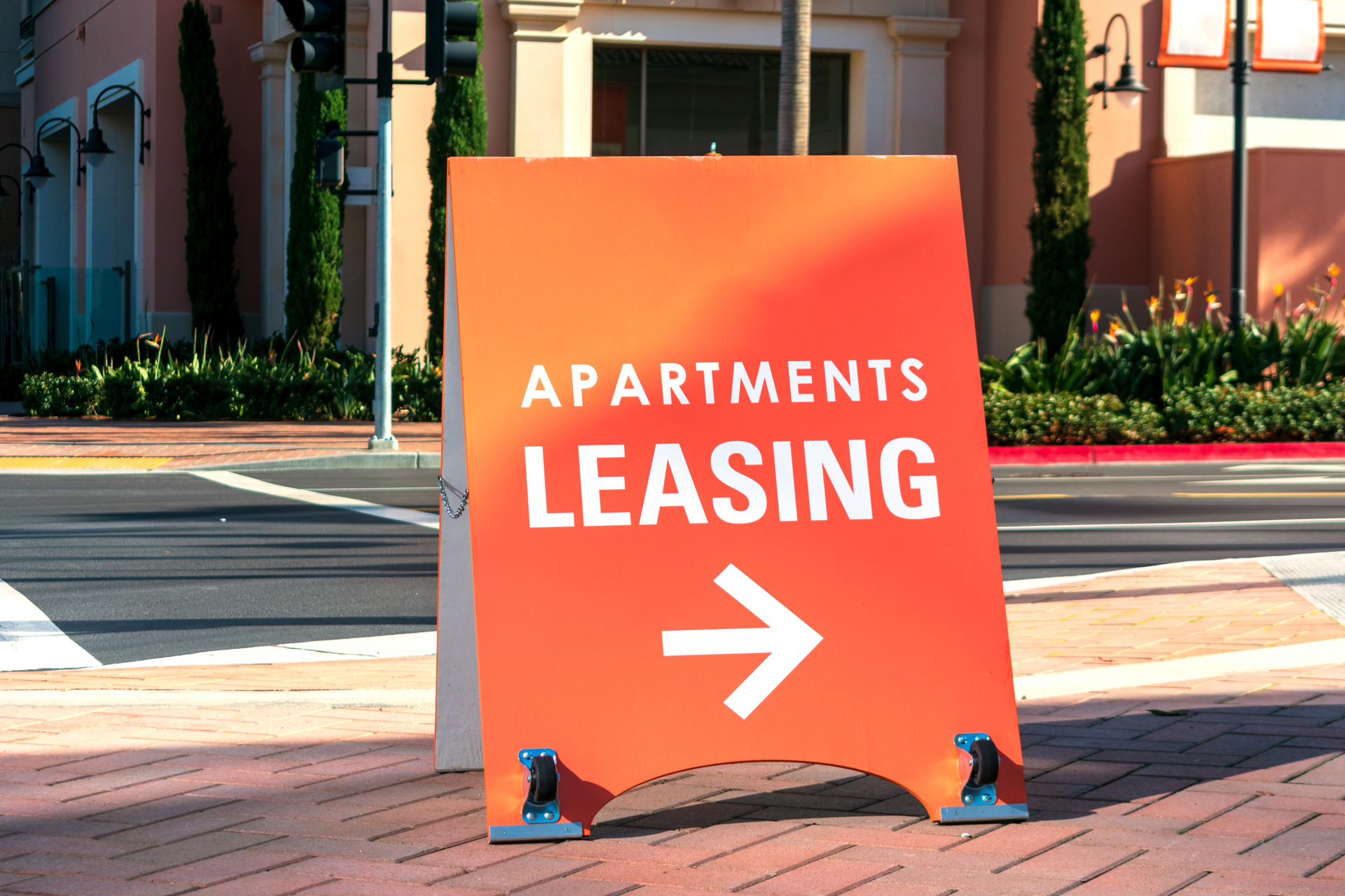 a sign that shows apartment leasing on a street intersection