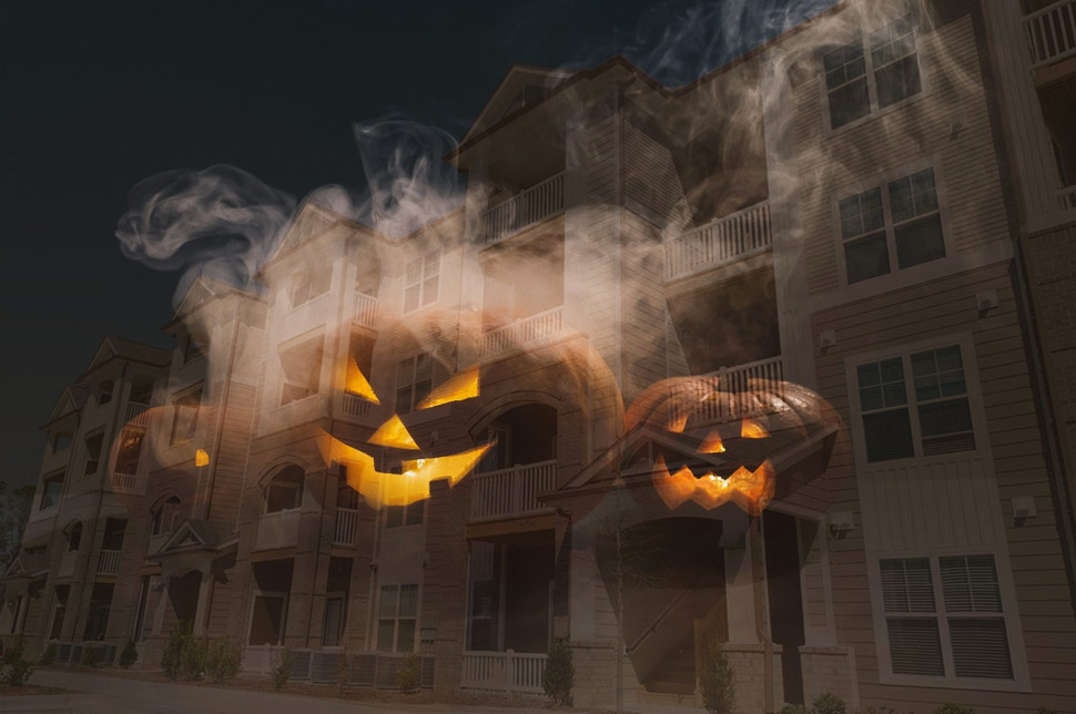 spooky pumpkins with smoke against an apartment complex